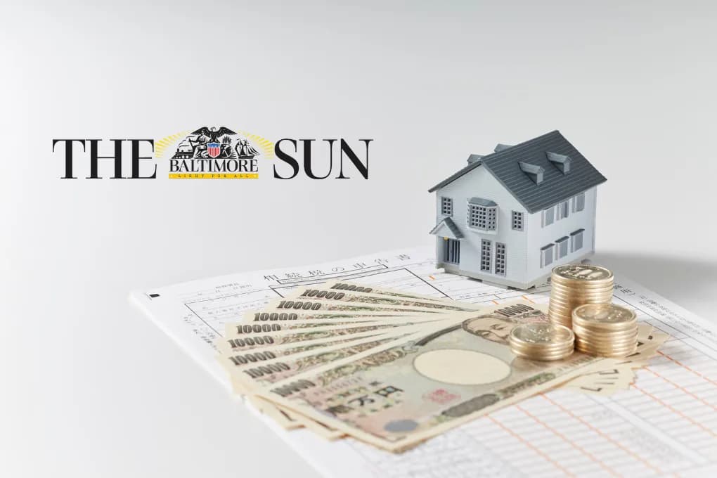 Toy house with money on a table, and the Baltimore Sun logo.