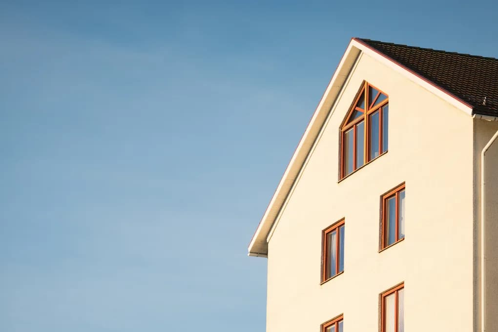 The top portion of a single-family home with a blue sky background.