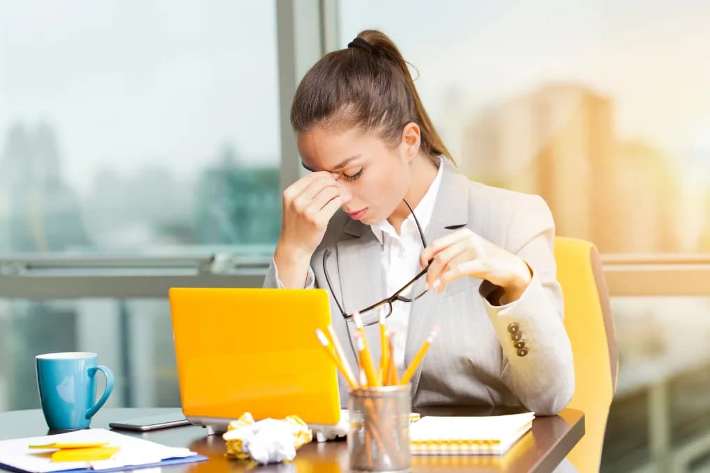 Landlord stressed while she looks at her computer.