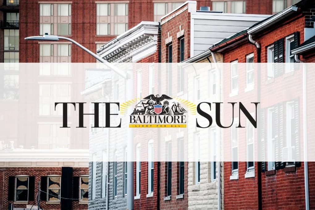 Baltimore City row homes with a Baltimore Sun Logo in front.