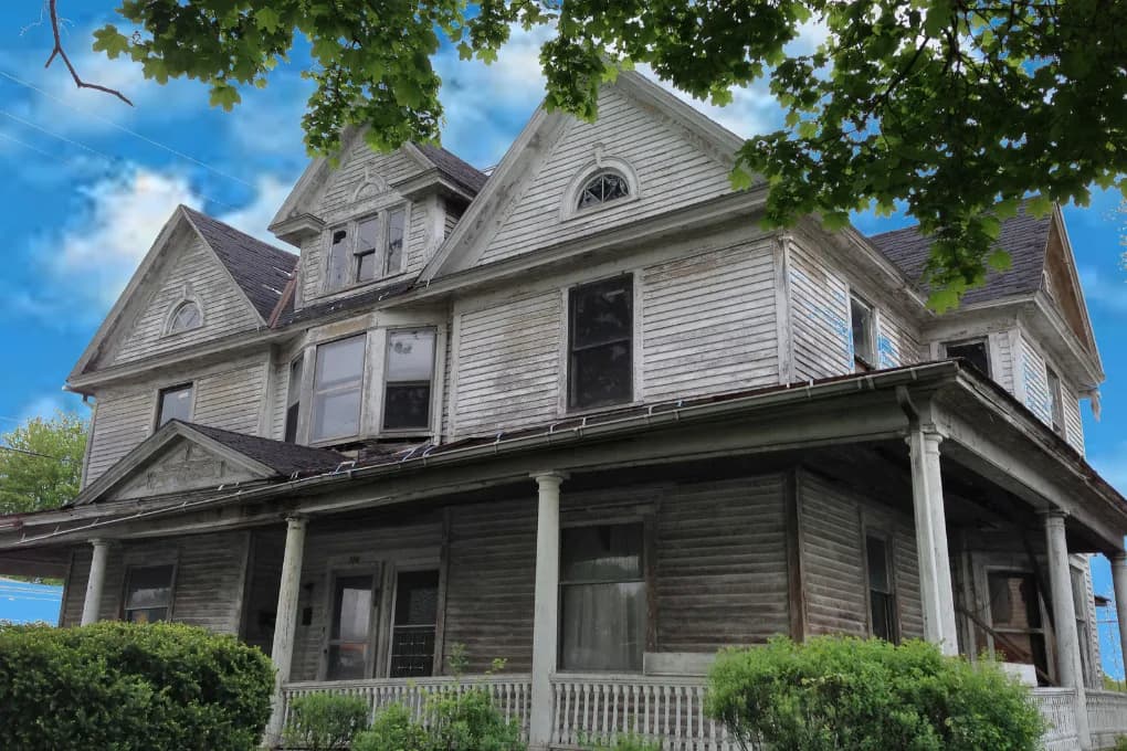 Street-view of an old home in need of repairs.